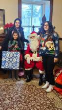 The Hernandez family poses for a photo with Santa at the Center for Prevention &amp; Counseling’s annual holiday party Saturday, Dec. 2. (Photos by Ava Lamorte)