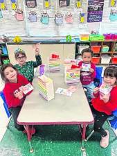 Kindergarten students at Durban Avenue Elementary School in Hopatcong show Valentines they made for their crossing guards. (Photo by Lisa Schuffenhauer)