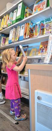 New mobile library launched <b>DOT1 Mavis Clawson, 2, of Sandyston looks at books in Sussex County’s new mobile library, Dot. (Photos by Theresa Esposito)</b>