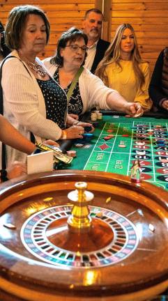 Photos: Casino Night fundraiser <b>Guests play their bets for roulette at the Sussex County Fairgrounds in Augusta.</b>