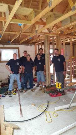 Members of the Sussex County Master Plumbers Association help build a house for Habitat for Humanity.