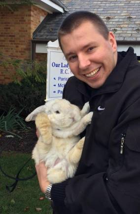 Father Kamil of Our Lady of the Lake holds a rabbit he blessed on Oct. 4, 2019. He also blessed, hamsters, cats, and dogs, who were given treats courtesy of Sparta Pet and Spa and WaggMore Pet Boutique.