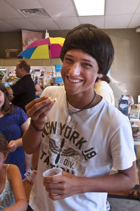 Sparta Books celebrates Waldo's birthday Roman Ivaldi, 14, of Andover enjoys some popcorn at the Where's Waldo party
