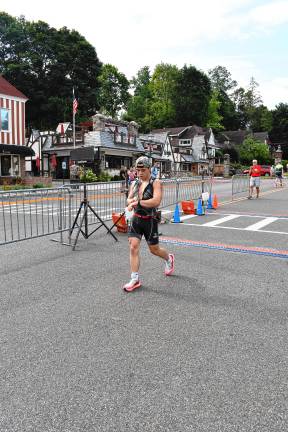 Photos: Pass it Along’s 14th annual Triathlon Aidan Diaz, 20, of Sussex checks his time after crossing the finish line. He was second overall, finishing first in cycling, third in swimming and fourth in running.