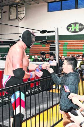 One of the wrestlers greets a young fan at the Independent Superstars of Pro Wrestling (ISPW) fundraiser Friday, April 12 at Hopatcong High School.
