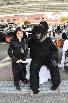 Byram school hosts trunk or treat Jonathan Church posing with a gorilla character.