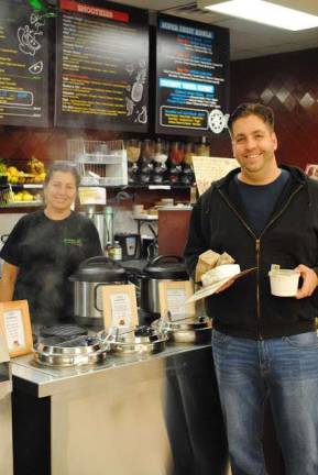 Specialty organic food store opens Mervet Yassin, left, with a customer, Paul