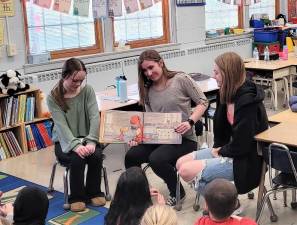 Interact Club members read to elementary students. (Photo provided)