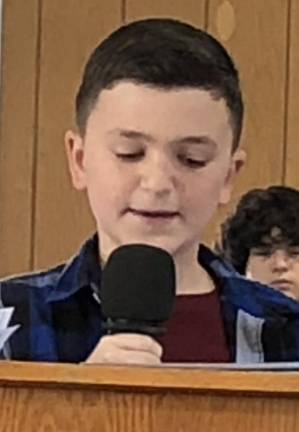 Veterans honored with parade, ceremony Carter Bambara of Frankford Township School reads his essay.
