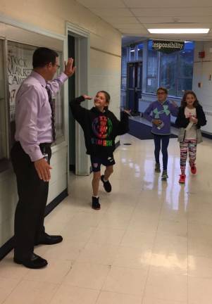 School kids inspired by 'Wonder' and kindness Assistant Principal Frank Ciaburri high fives Kindness Ambassadors Allyssa Ciaburri, Brielle Fastnacht and Victoris Suchich.