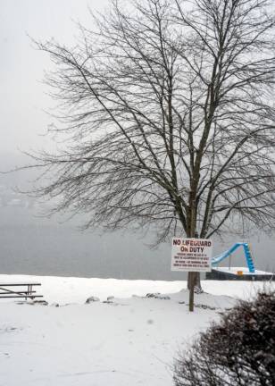 Snow covers a beach area at Lake Mohawk.