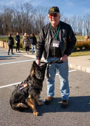 Ken Augustin and his dog Remy attend the ceremony.