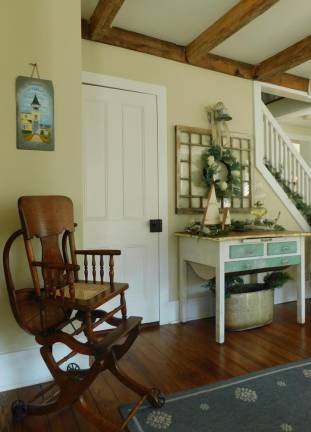 The front room of the 1840s Hunt's Mill house in Green Township boasts open beams, period furniture, and a slate painting of the Yellow Frame Church. The home will be part of the church's 27th Annual Holiday Home Tour on Saturday, Dec 7, 2019.