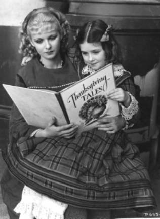 Actress Joan Bennett reads to Marilyn Knowlden on the set of Little Women (1933). Photo provided