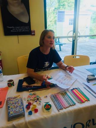 PSS Back to school Fair Devon Carroll, of NORWESCAP, educates visiting parents about what services they provide.