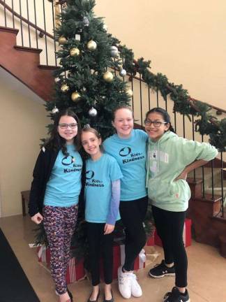 (Left to right): Julia Myers, 10, of Vernon, Gabby Kelly, 11, of Hamburg, Michaela Thoma, 11, of Vernon, and Isabel Heaney, 11, of Hamburg were important bag stuffers on Sunday as they prepared goodie bags to be distributed as part of Project Self-Sufficiency's Season of Hope. (Photo by Laurie Gordon).