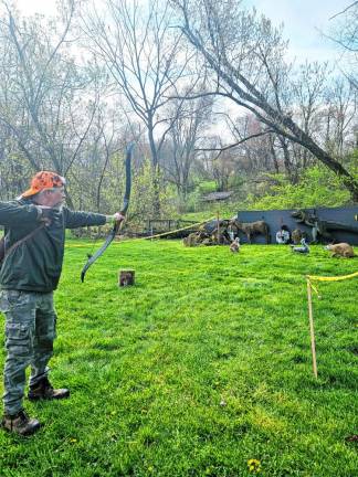 30th annual Traditional Bow Shoot BOW4 Andrew Harley of Pennsylvania aims at the targets.