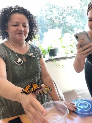 Pollinators find new safe space on campus Jennifer Nunez, Horticulture Science (left), admires butterfly while Taylor Austin, Agriculture Business, takes a photo. (Photo provided)