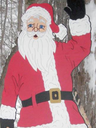 Wood cutouts of Rudolph and Santa created by John decorate the Westermajer front lawn (Photo by Janet Redyke)