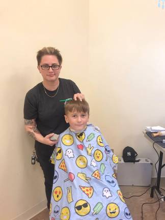 Charlie Catlin, of Allamuchy, receives a free haircut from Lisa Greene, owner of Blackbird Barber Shop. (Photos by Laurie Gordon)
