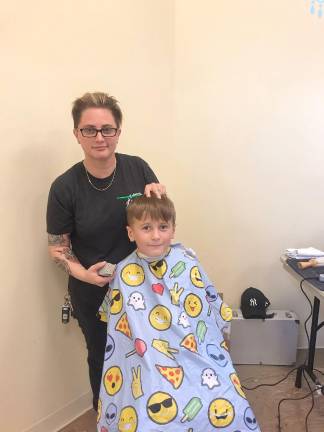 PSS Back to school Fair Charlie Catlin, of Allamuchy, receives a free haircut from Lisa Greene, owner of Blackbird Barber Shop. (Photos by Laurie Gordon)