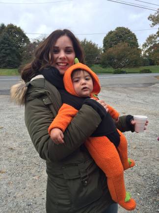 Apples, cider doughnuts and ice cream Amanda Carucci and her baby, Michael, enjoy some cider at Windy Brow en route to heading out to pick apples.
