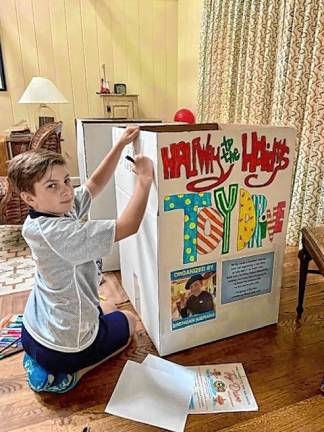 Boy starts Halfway to the Holidays toy drive Brendan Kierans, 11, of Sparta decorates a box to collect donated toys. (Photo provided)