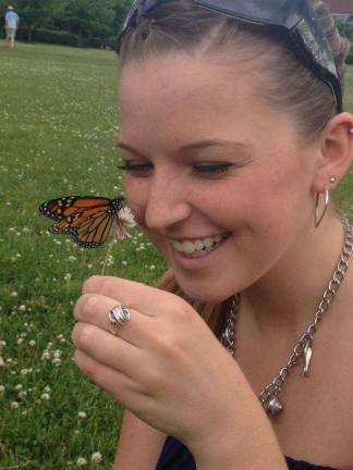 Butterfly Release Celebration guest Erin Optiz welcomes a newly released Monarch butterfly at a previous Butter Release Celebration.