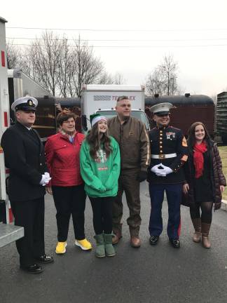 From left, a US Marine from Picattinny Arsenal, Lorraine Parker, Meghan Tobin, a representative of UPS, Gunnery Sgt. Clayton, and a representative of Project Self-Sufficiency