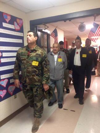 Area veterans parade into the school gym.