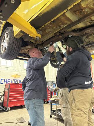 From classroom to career <b>Jason Fruge</b>, Sussex County Community College’s dean of technical occupations, and students repair a vehicle.