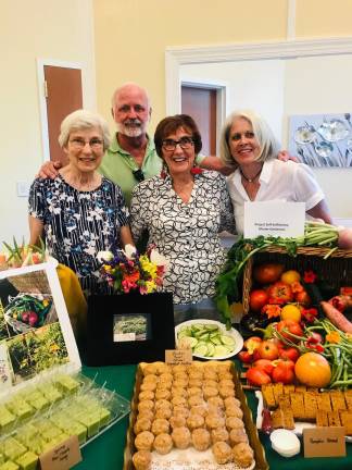 Volunteers for the Project Self-Sufficiency garden showcase some of their vegetables which are available to those in need from May through November (from left to right: Master Gardner Mary Spector, Michael Foley, Rhoda Seider, Pat Foley).