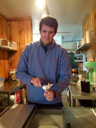 Apples, cider doughnuts and ice cream Jake Hunt dishes out some of his famous ice cream.