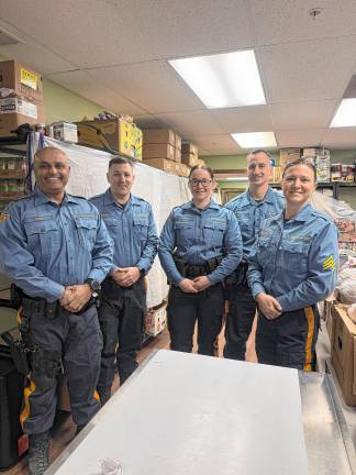 Community food pantry turns 40 State troopers help out at the Sparta Community Food Pantry. (Photo provided)