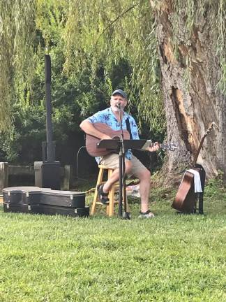 Brian McLoughlin sings Jimmy Buffet's Margaritaville at a concert at Paulinskil Lake on Saturday, Aug. 17. (Photo by Laurie Gordon)