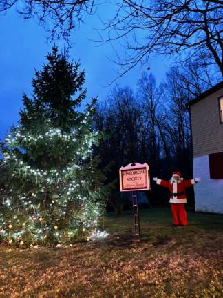 Santa stands near the Stillwater Christmas Tree.
