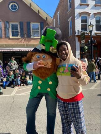 Addie Lillo of Newton takes a selfie with a leprechaun. (Photo by Laurie Gordon)