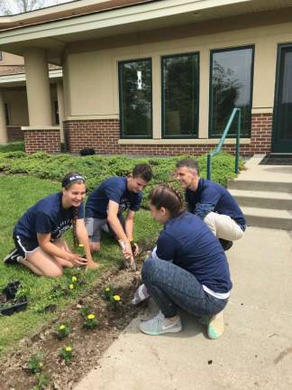 Head of School Chris Fortunato (back right) is joined by a staff member and students Maruta Sipols (front left) and Jack Weber (back left) during the Blair Day of Service at Project Self-Sufficiency.