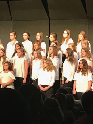 Esprit de Corps Award underscores Kittatinny's pride for music Members of the Kittatinny Junior High Seventh Grade Choir perform "Hushaby Mountain." Emily Popek, of Stillwater, was a soloist in the number. That and "Shine on Me" earned them first place in their division at the Kutztown University competition. Photo by Laurie Gordon