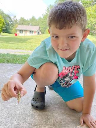 A Wet &amp; Slimy camper (entering 3rd or 4th grade) and his friend at the Pocono Environmental Education Center’s Nature Day Camp. You make all kinds of friends at summer camp. Provided photo.