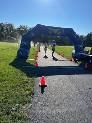 More runners cross the finish line.