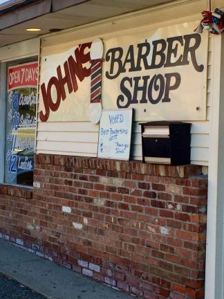 Contrary to the rumors, John's Barber Shop is open for business and plans to be around for a long time