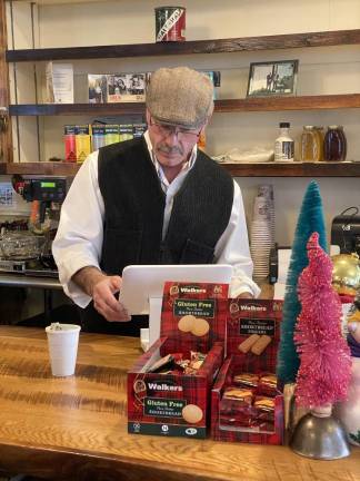 Dean Voris, the mastermind behind bringing the store back waits on customers early morning on opening day.