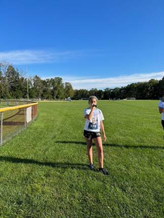 Grace McEvoy of Frankford sings the National Anthem before the run.