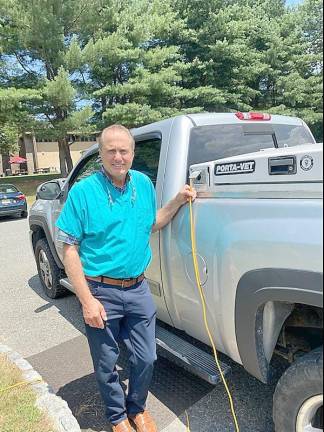 Dr. Ted Spinks stands next to his retrofitted traveling truck to make house calls.