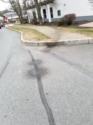 Routine traffic stop leads to chase, crash, and apparent escape attempt Oil stain leading to the tree in front of NBT Bank (Photo by Ken Hubeny Sr.)