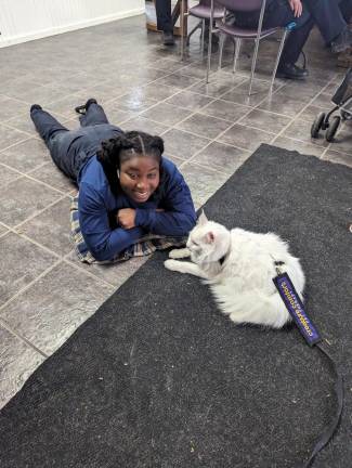 Therapy cat warms hearts Squad member Patience Hevi hangs out with Mutzzie.