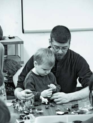 Lego builders start young Matt, 3, and his father Timothy McQueen work together during the Lego club meeting Saturday.