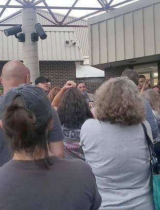 School board president Jack Fisher answered questions from anti-mask protesters outside the high school, where the Sept. 9 work session was held. (Photo courtesy of Tim Sohn)