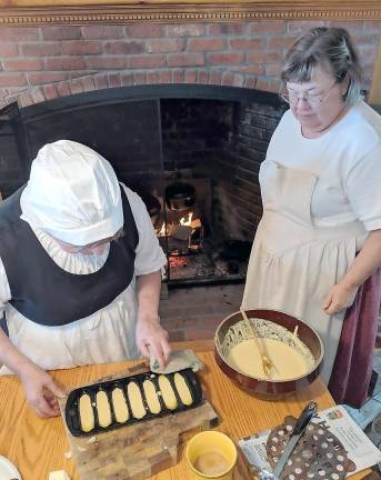 Una Leere prepares Corn Styx and Jane pours the batter to place in the Beehive Oven.
